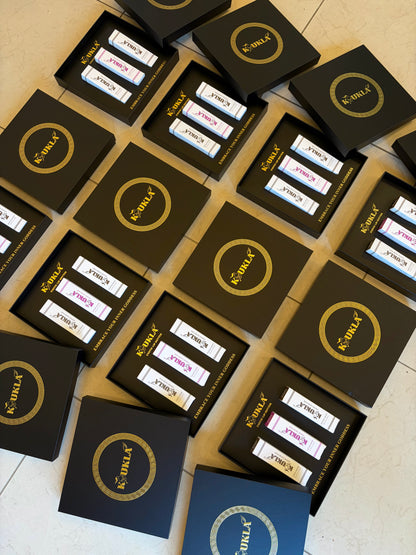 Multiple boxes with "Koukla" branding on a tiled floor.