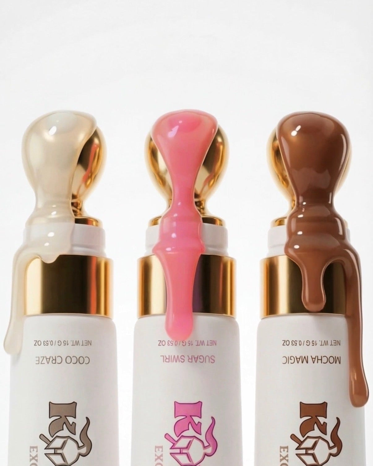 Three lip gloss bottles with different colored liquids on a white background